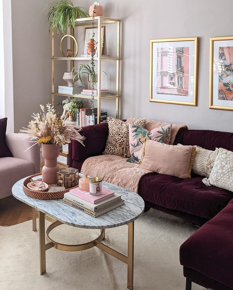 Gorgeous sofa styling by Swoon Worthy with a beautiful burgundy velvet sofa and pink patterned cushions