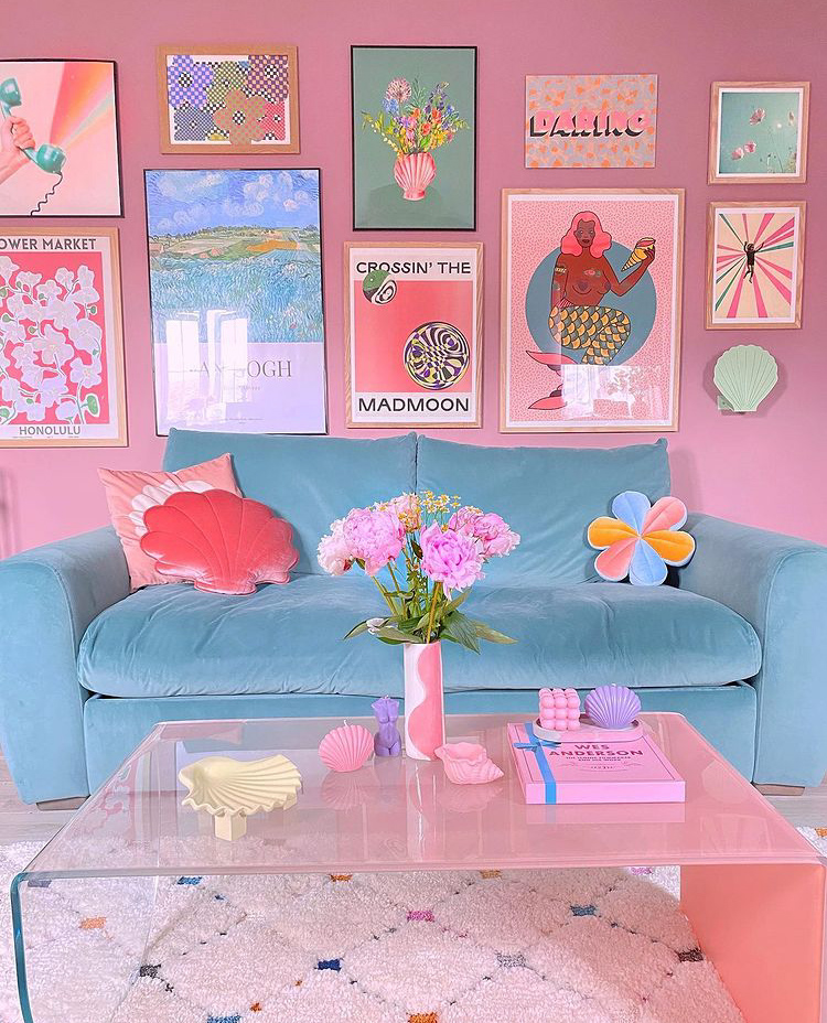 Gorgeous pastel pink and blue decor. Simply styled sky blue velvet sofa with pink shell cushion and flower cushion, and quirky gallery wall.