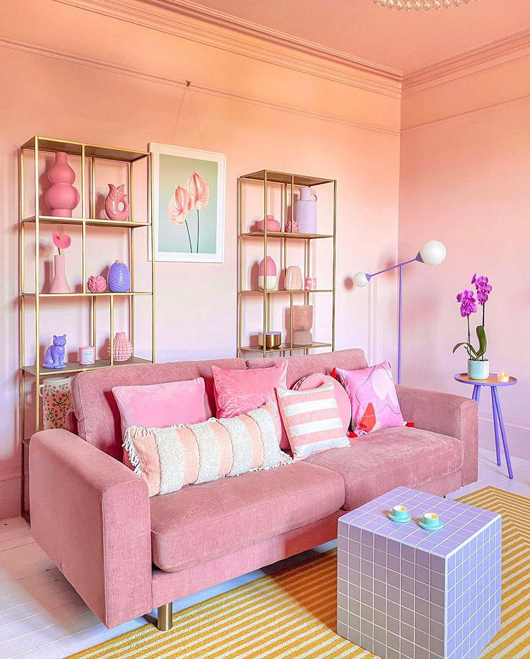 Colour drenching done right! Pastel pink living room with tonal pink cushions and pink sofa