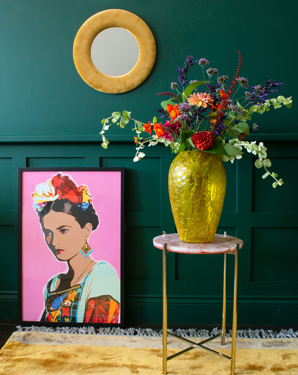 Colourful interiors - pink Frida print styled with yellow glass vase and velvet mirror