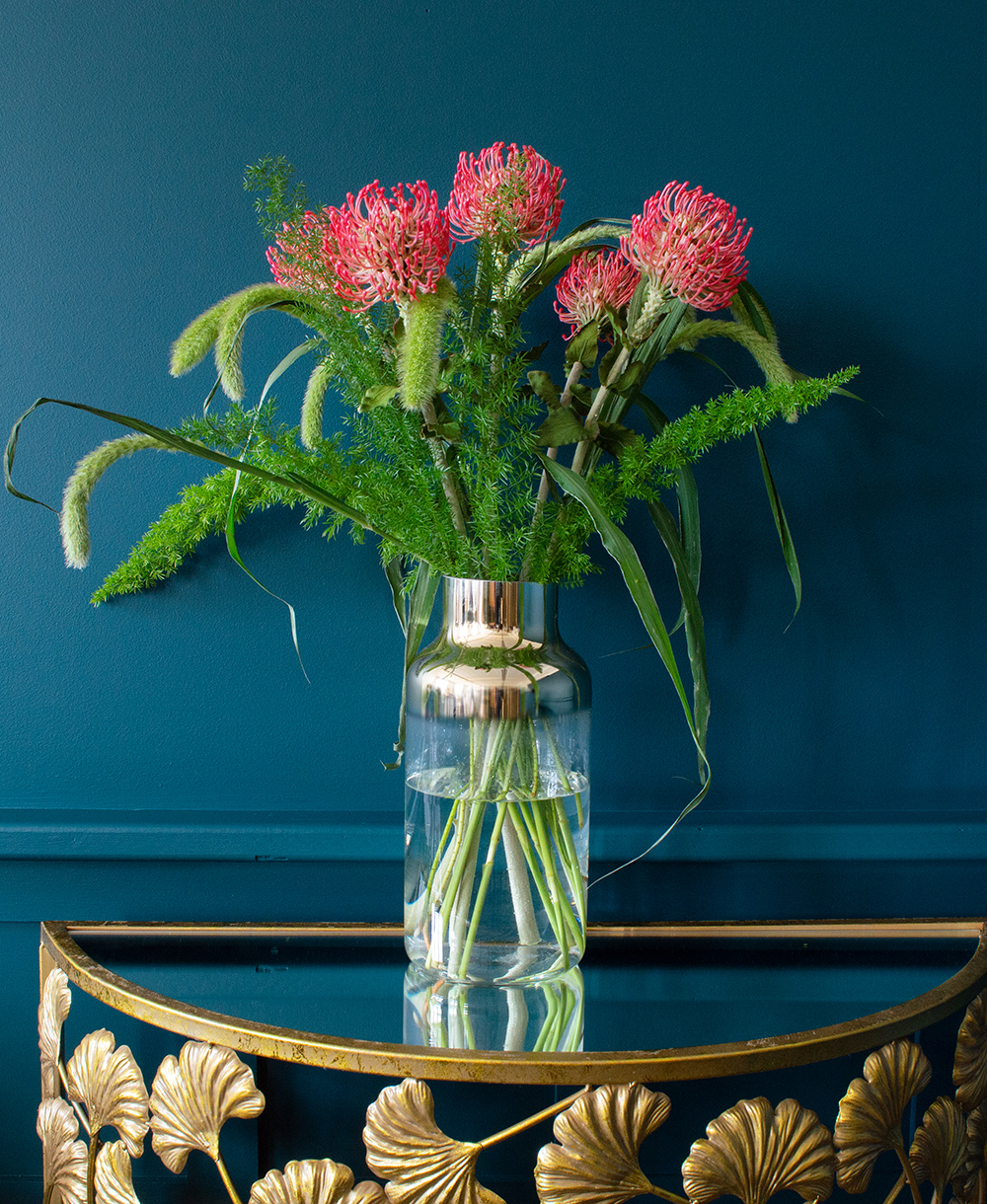 Tips for flower arranging - mix in artificial flowers like these pink protea stems