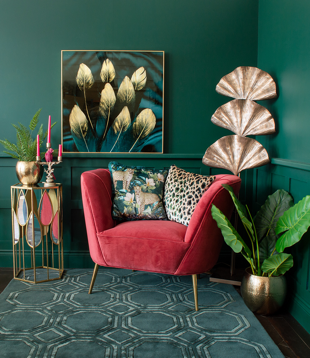 Green living room inspiration. Styled with cherry pink velvet armchair, colourful wall art and lots of gold home accessories and furniture. All available from Audenza