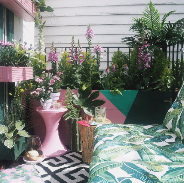 Pink is perfect for outdoors. See how fabulous it is on this balcony where it echoes the planting and gives a harmonious mix with the green. Pastel pink and green is just the perfect combo.