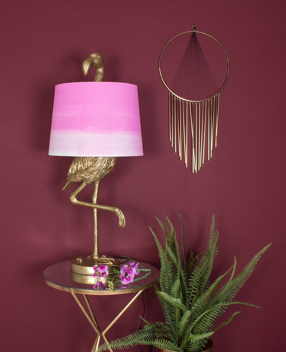 Gold decor styling tips. A definite wow-piece, the brass flamingo table lamp with ombre shade, adds that touch of exotic gold even on a traditional wooden table.