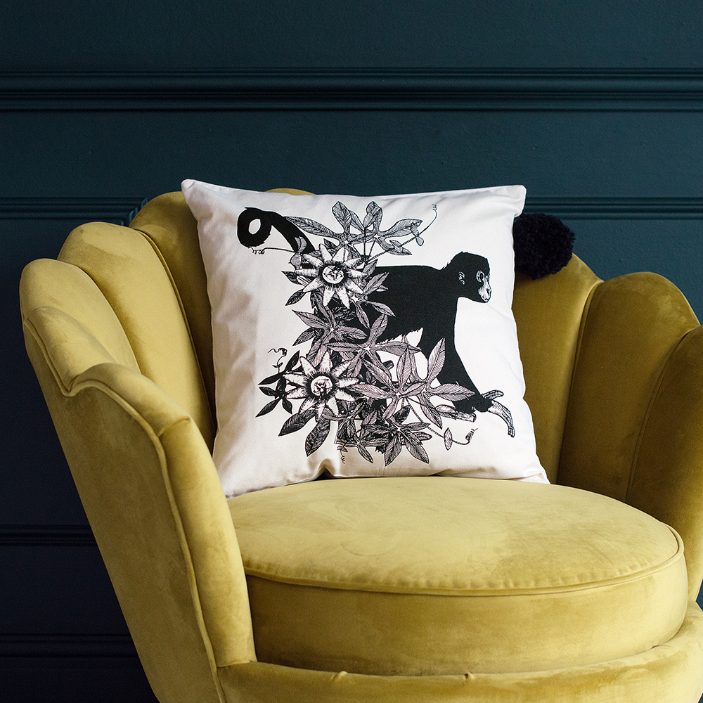 Audenza- Top 10 Cool Homewares Under £50. Hand drawn and hand painted illustrated spider monkey cushion.
