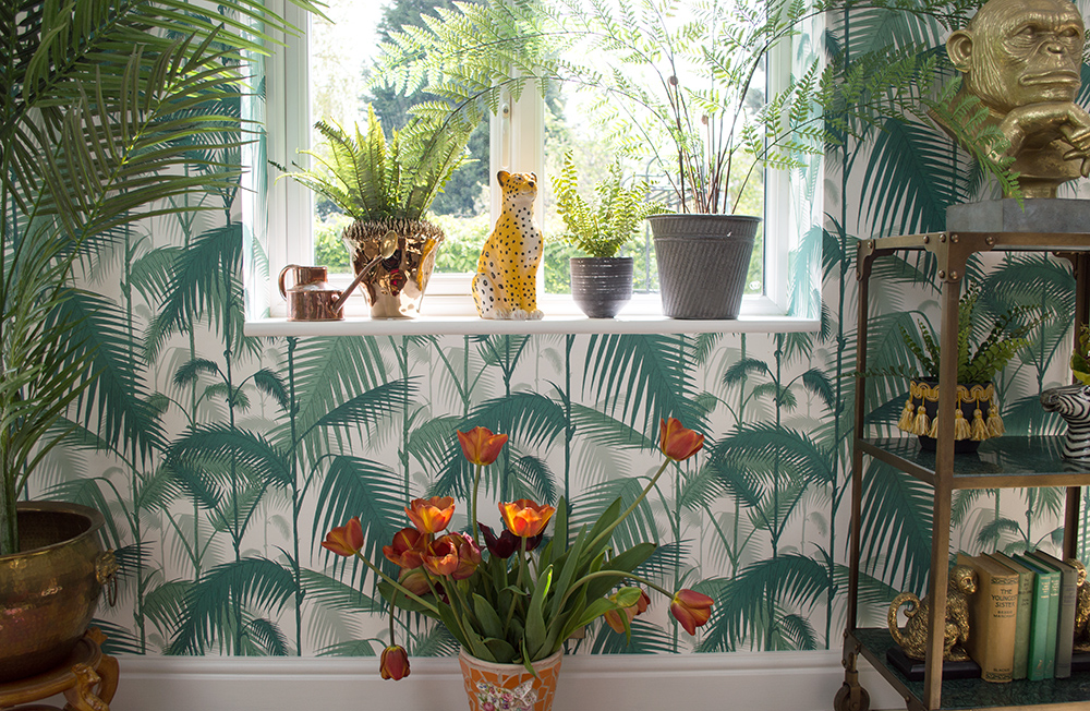 Tropical inspired garden room. Get the look- combine palm wallpaper with lush house plants and plenty of quirky animal ornaments.