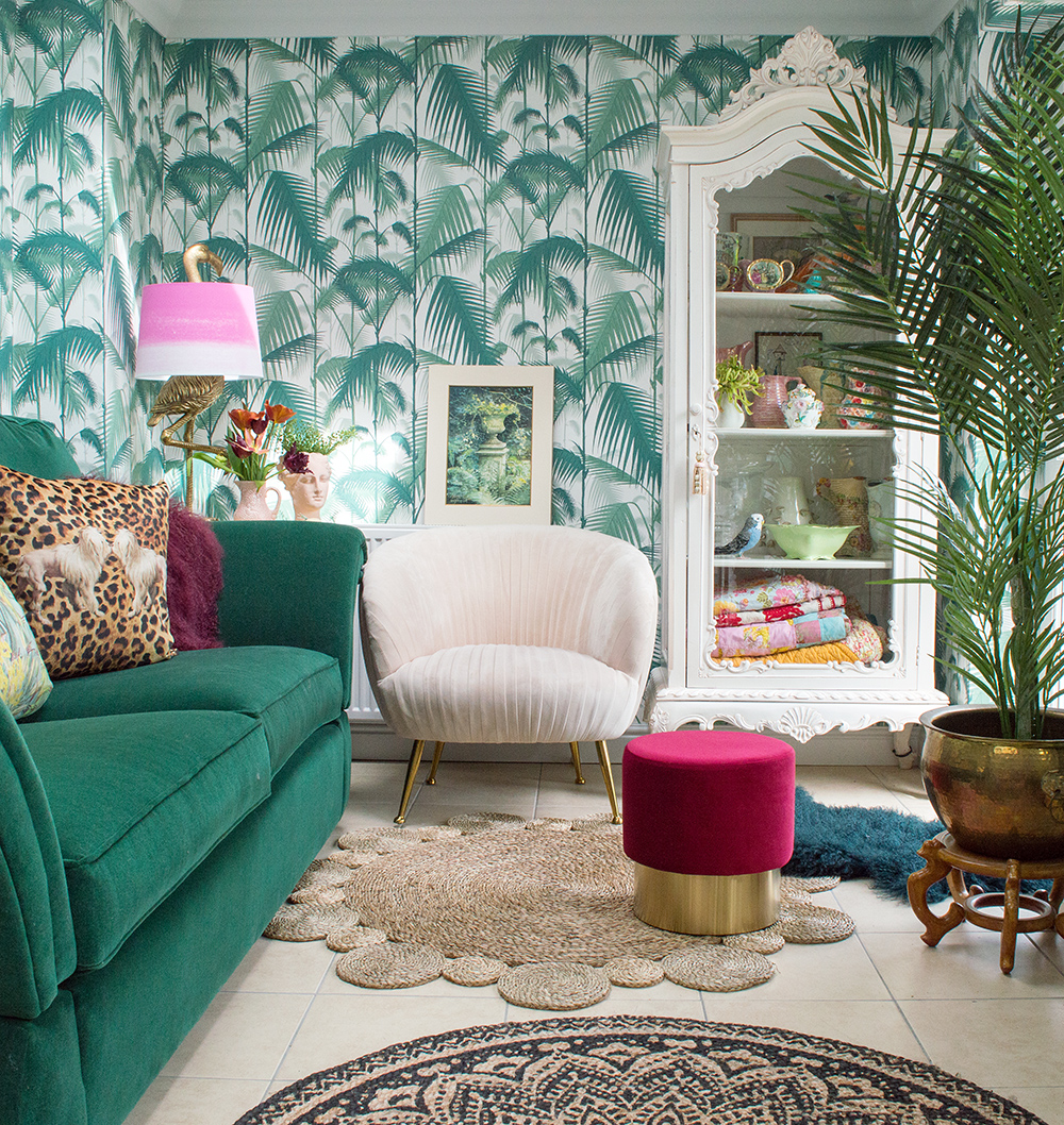 Tropical living room inspiration featuring Cole & Son wallpaper, a stunning green velvet sofa, and blush pink velvet armchair.