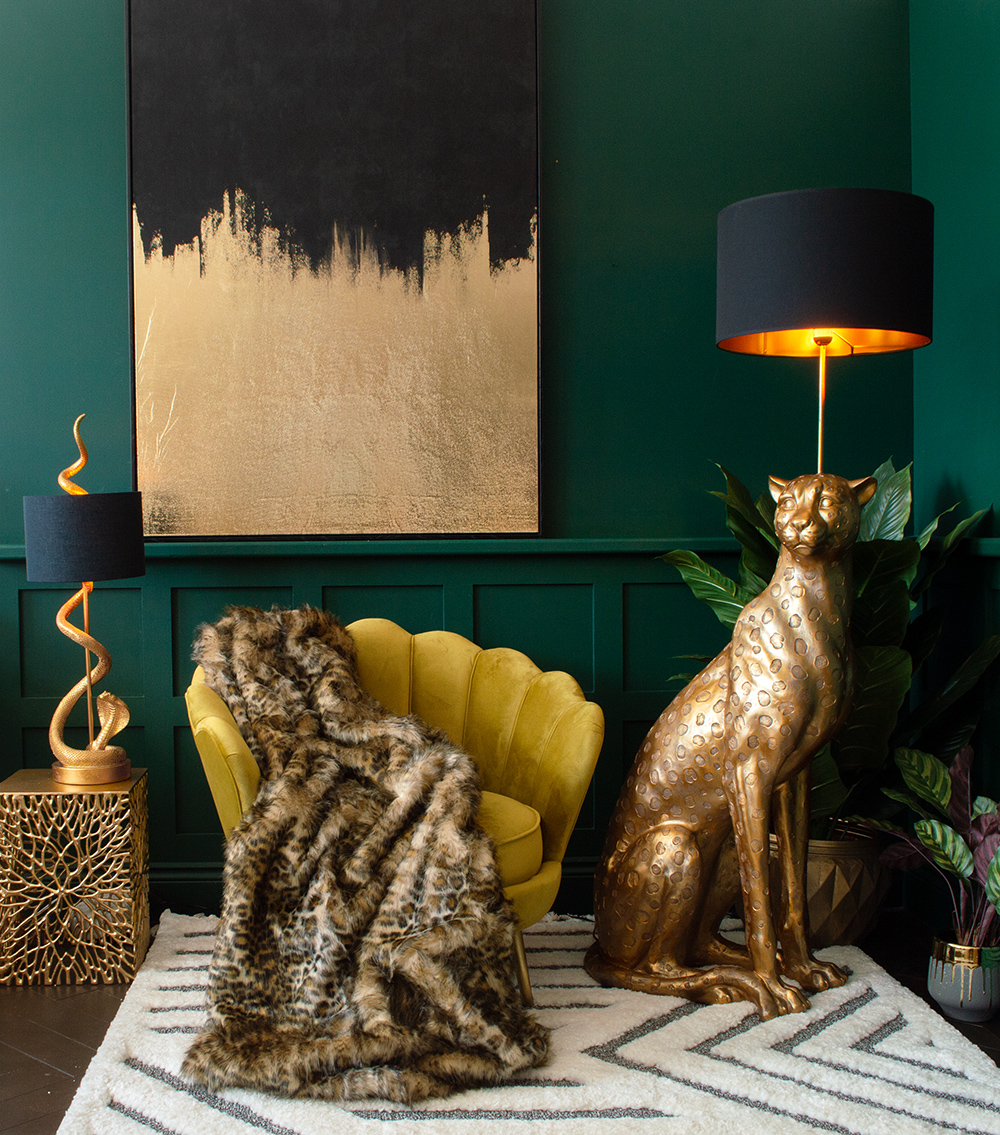 Moody green living room decor. Large leopard floor lamp with mustard velvet armchair and faux fur leopard print throw