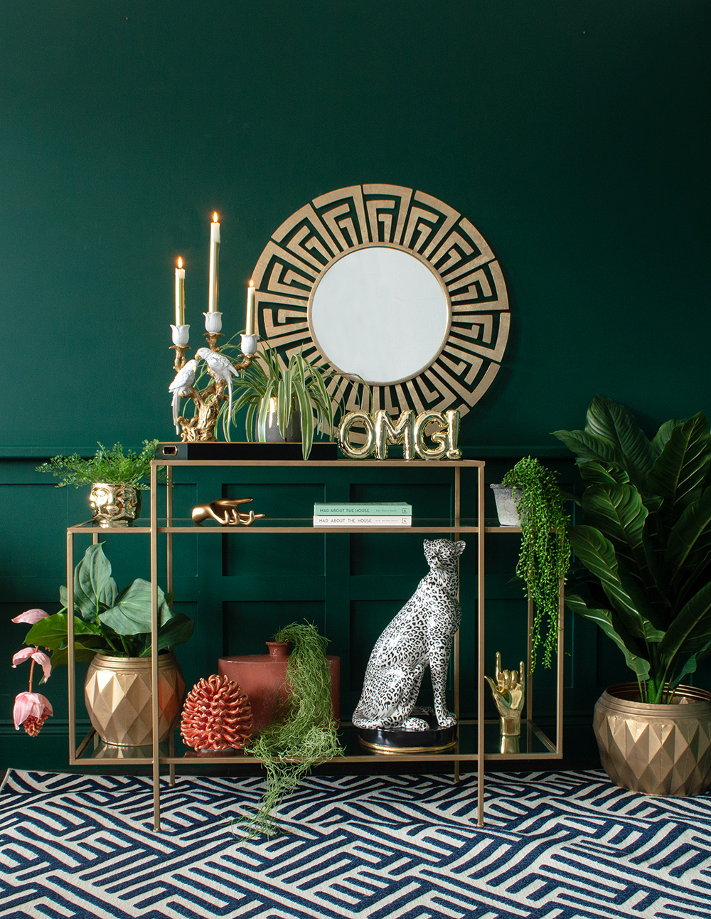 Dark green living room with Greek Key Gold Mirror, Tiered Gold Console Table and lots of cool, quirky home accessories. All by Audenza
