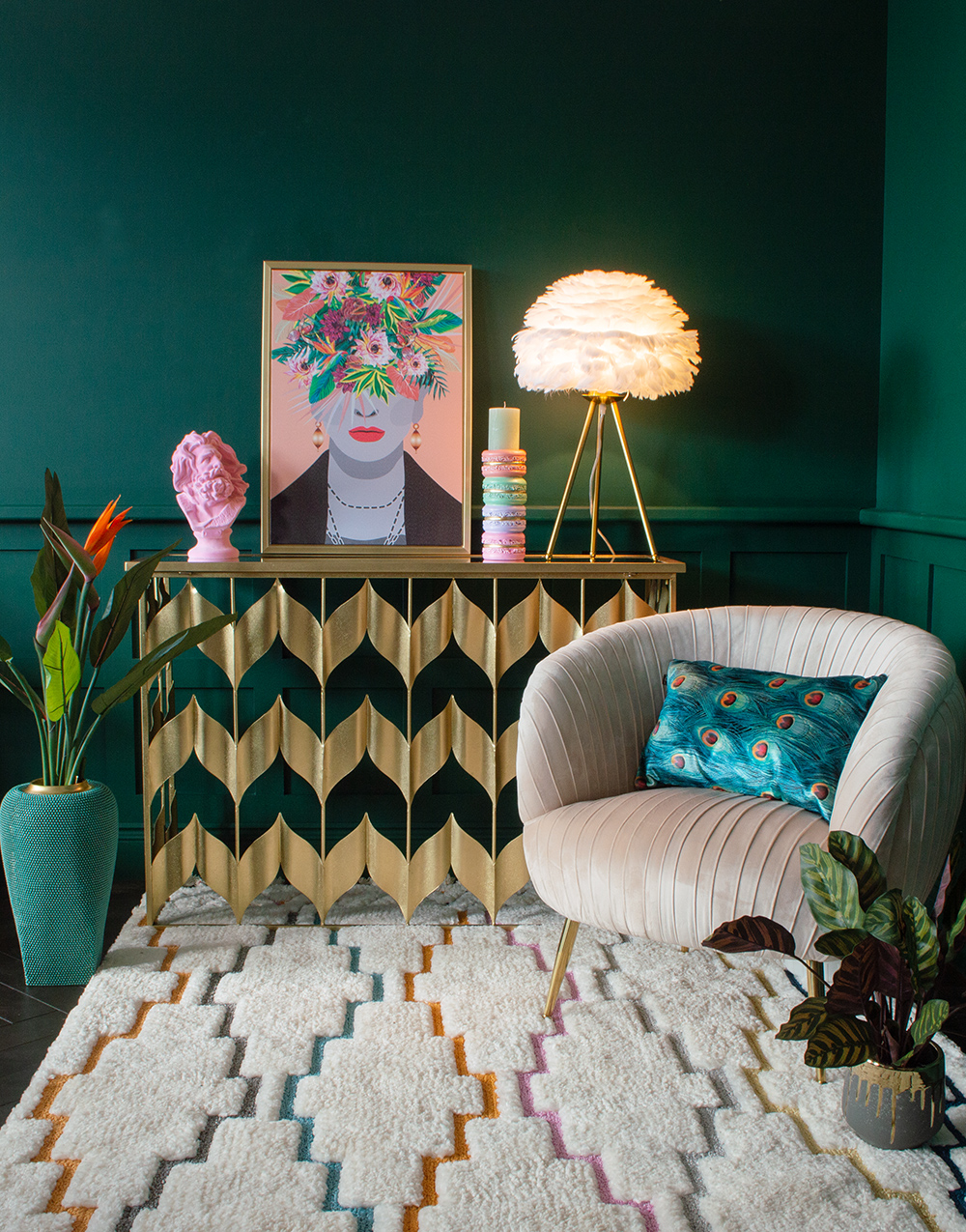 Green living room inspiration with pink and gold furniture and home accessories. Colourful Frida Kahlo inspired artwork with pink velvet armchair and gold console table
