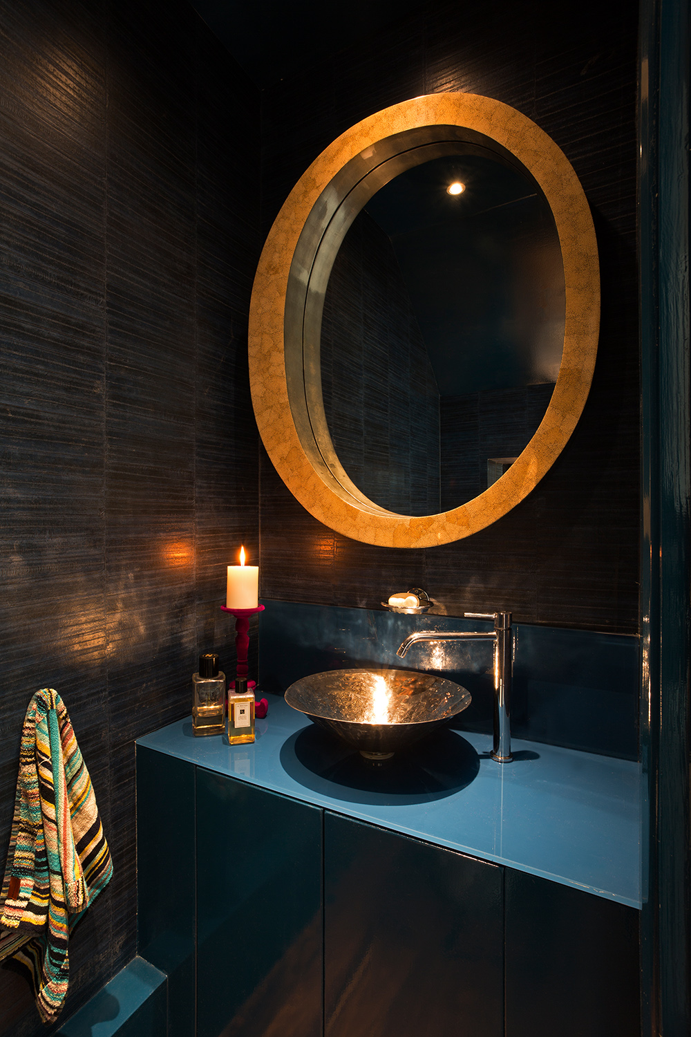 A dark and moody bathroom with modern fittings.