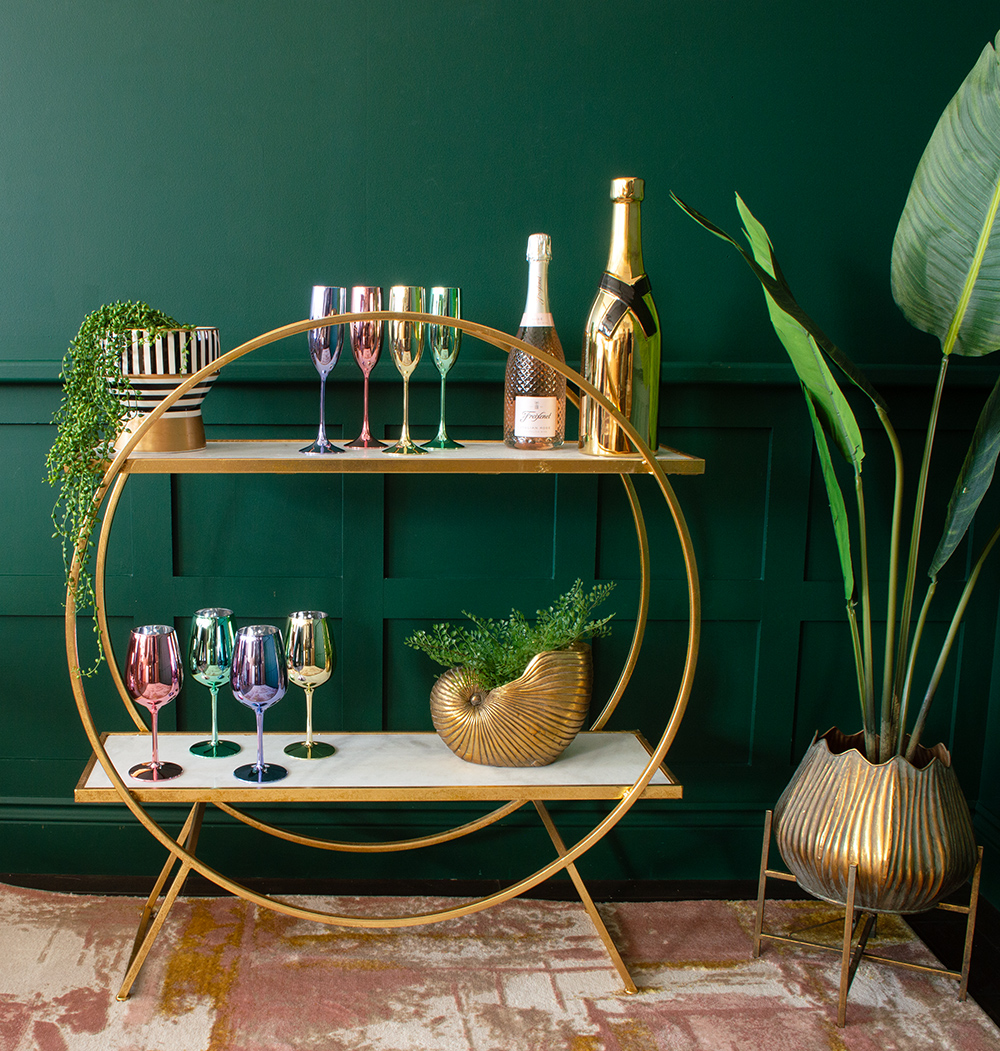 Gold round drinks stand, perfect for creating your own home bar. Looks fab styled in a dark green living room with colourful wine glasses and prosecco flutes.