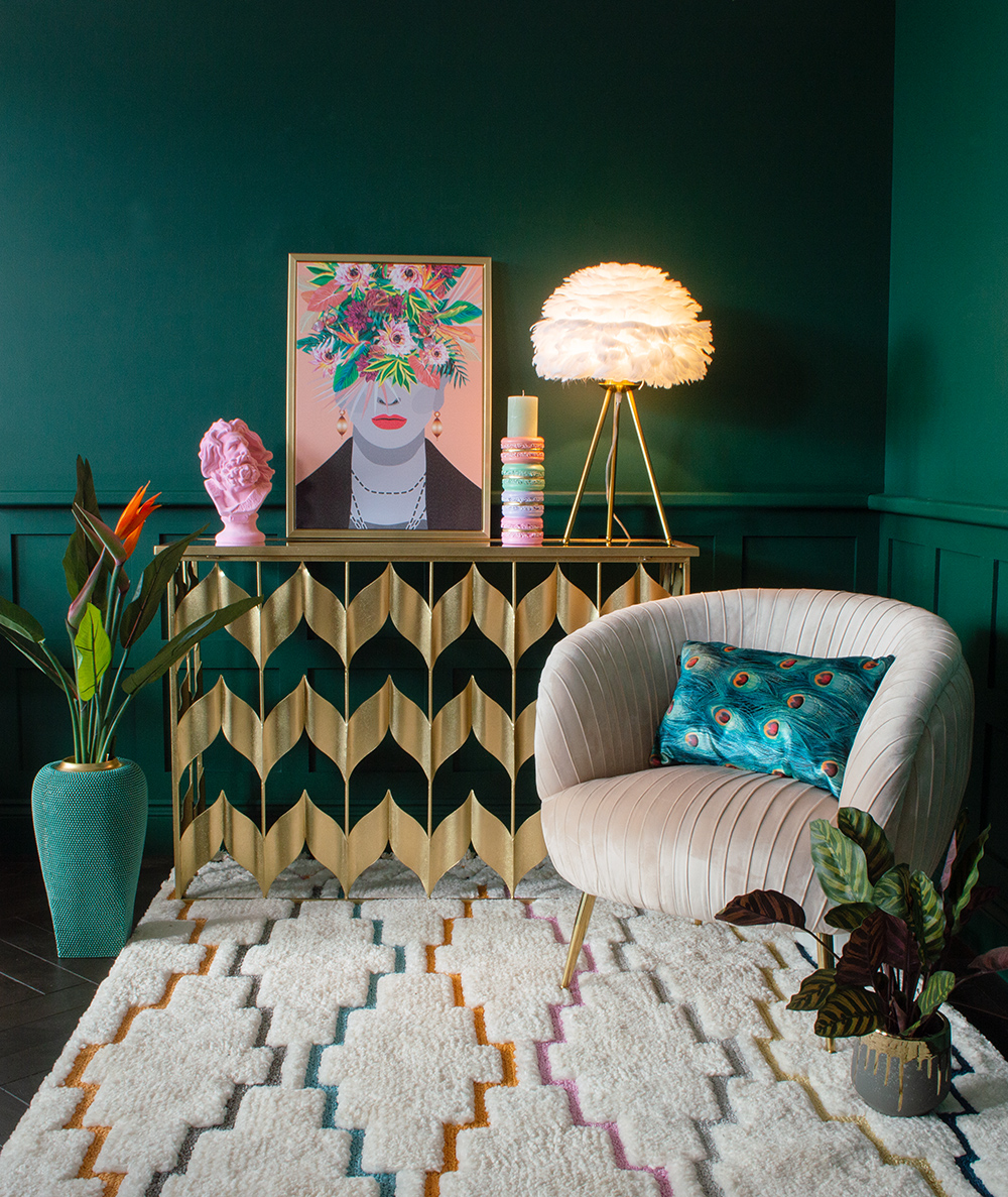 Pink velvet pleated armchair with glam, gold chevron console table and quirky, pastel home accessories