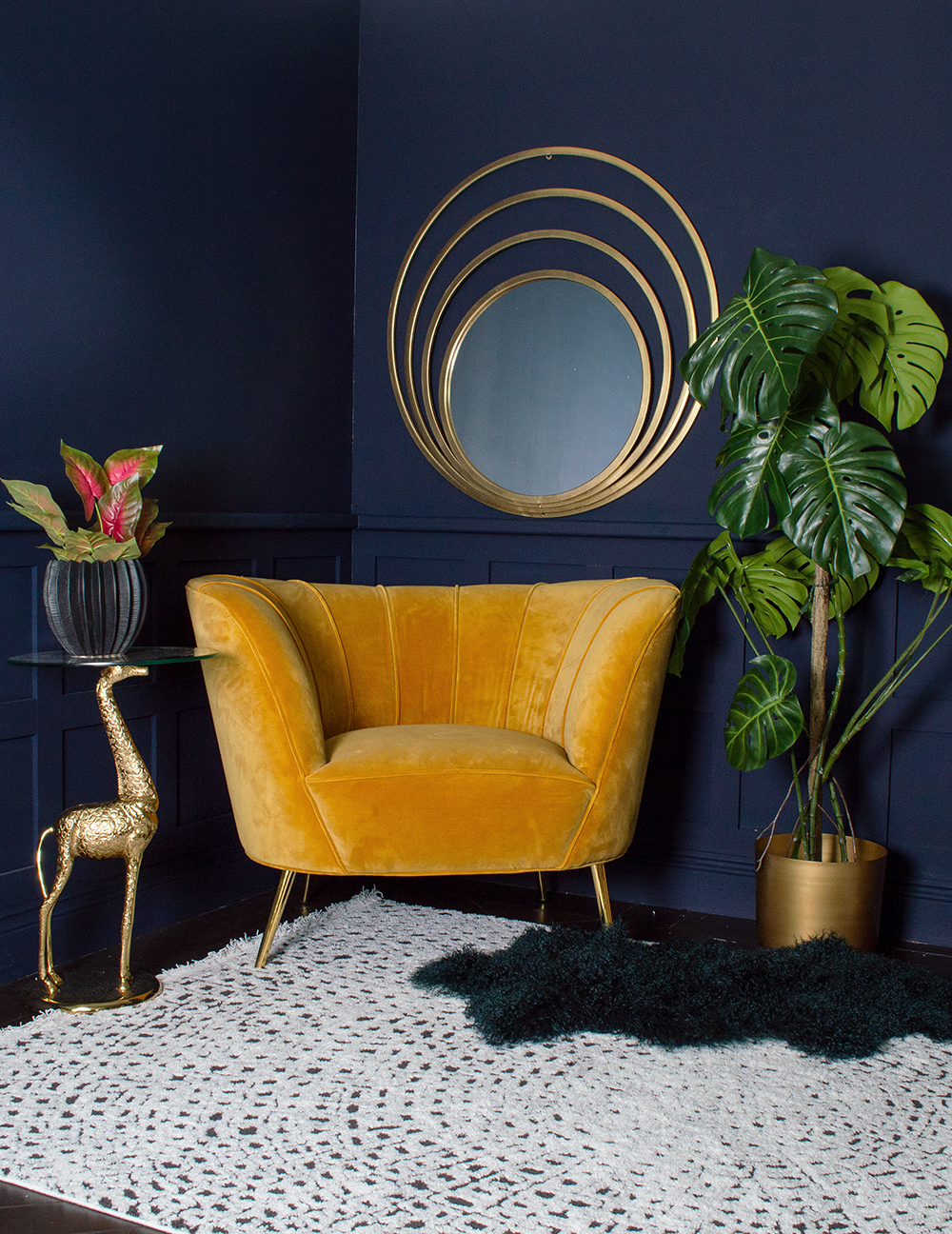 Dark navy blue living room with gorgeous mustard yellow velvet armchair