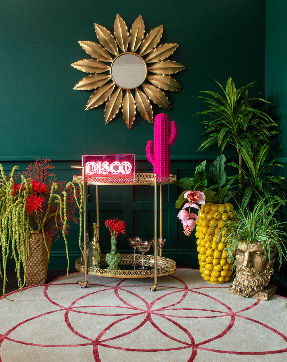 How to style a drinks trolley - don't forget to add a neon light! Throw in plenty of cool glassware, house plants and a statement wall mirror and voila!