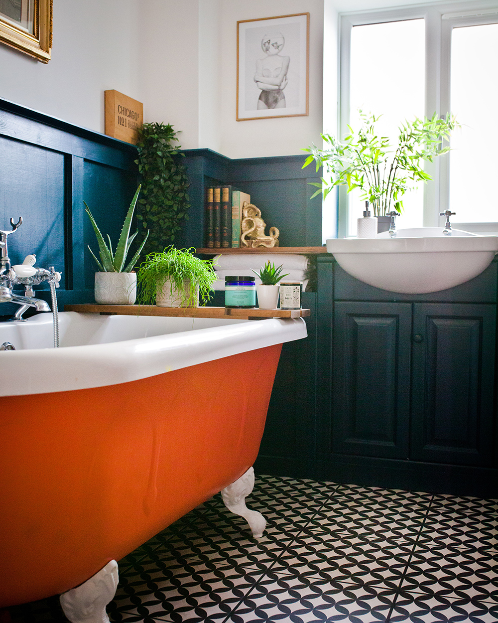 Colourful family bathroom with orange claw foot tub