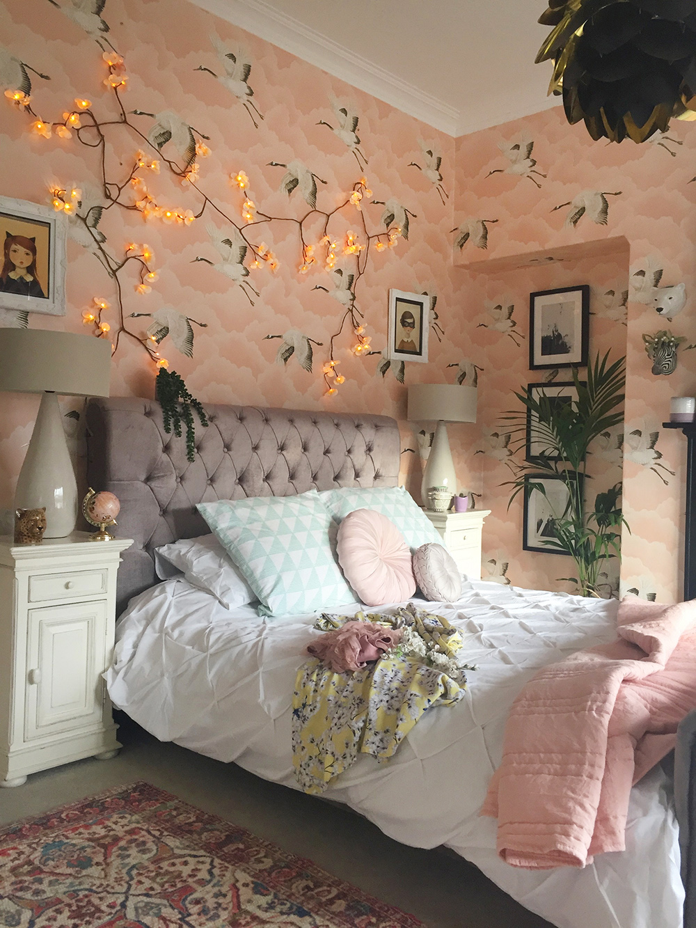Feminine blush pink bedroom decor with 'Cranes in Flight' wallpaper by Harlequin. 