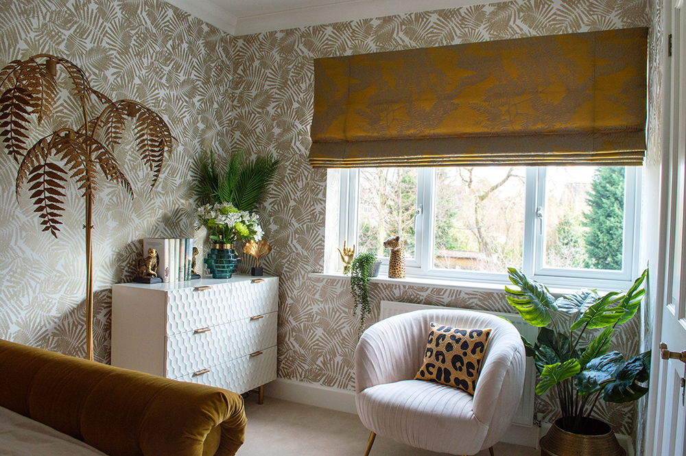 Glam and feminine bedroom with blush pink velvet armchair.