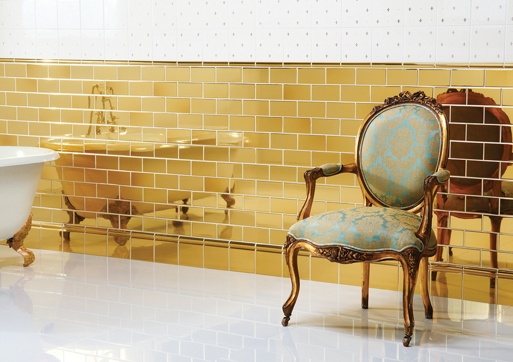 Gold metallic metro tiles paired with a gold skirting tile and gold moulding. So decadent and so ritzy! By Original Style Tiles