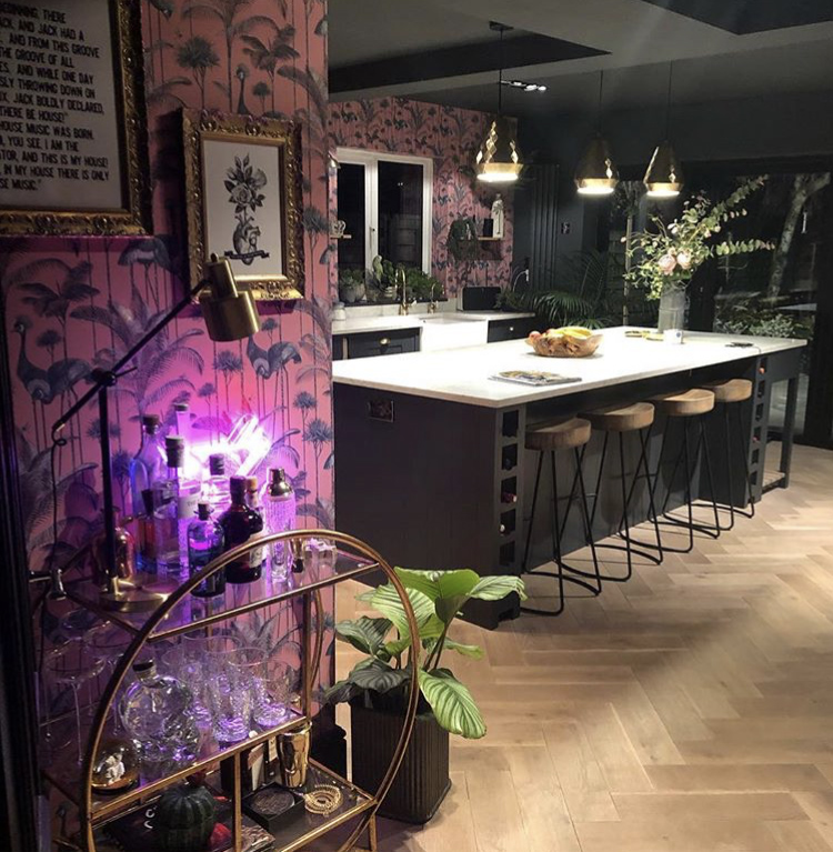 Gorgeous dark and moody kitchen with Crane Fonda wallpaper by Divine Savages and Gold Luxe Round Drinks Trolley from Audenza.