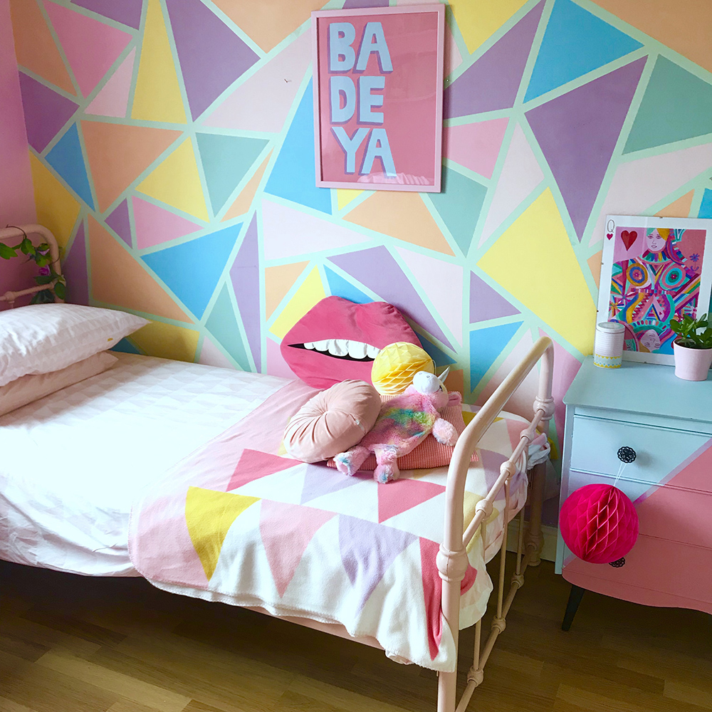 Bedroom inspiration with pastel patterned geometric wallpaper.
