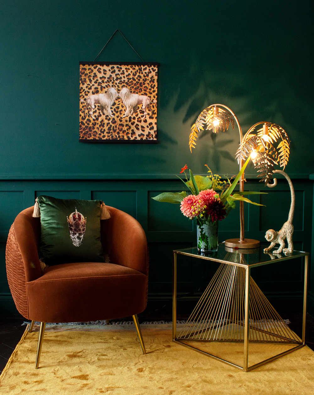 Moody green living room with leopard print wall art.