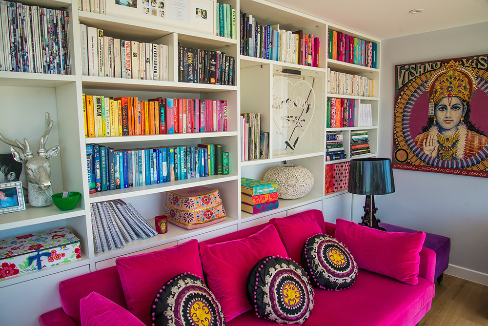 Reading nook with hot pink velvet sofa