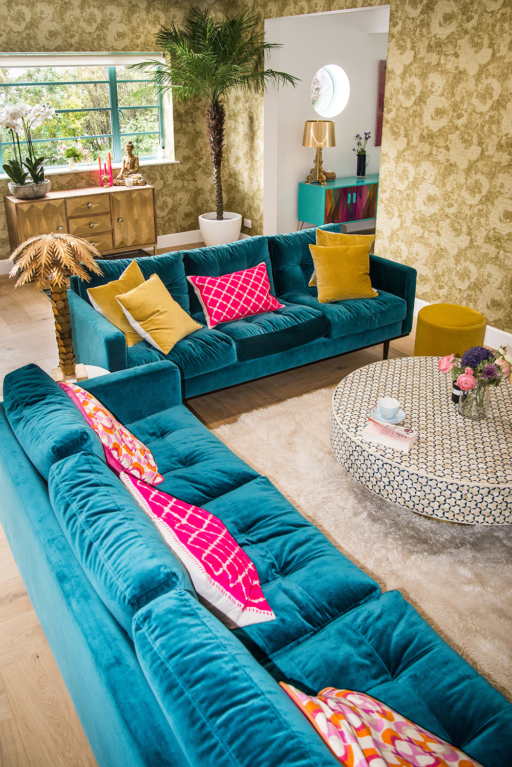 Eclectic living room inspiration with blue velvet sofas and gold accessories