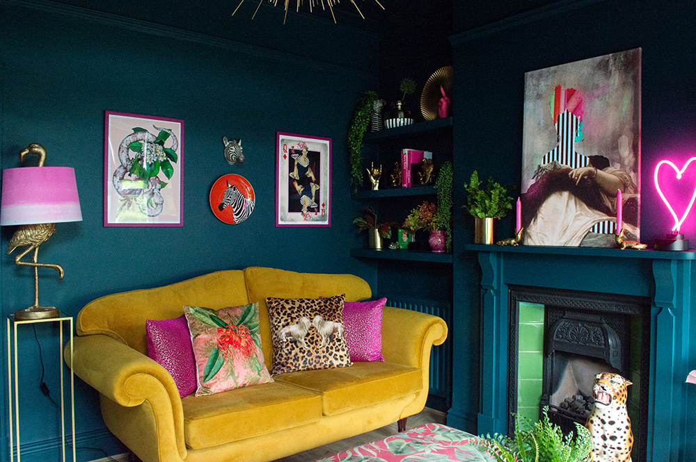 Eclectic, moody living room inspiration. Colourful, unusual wall art, paired with quirky animal homewares.