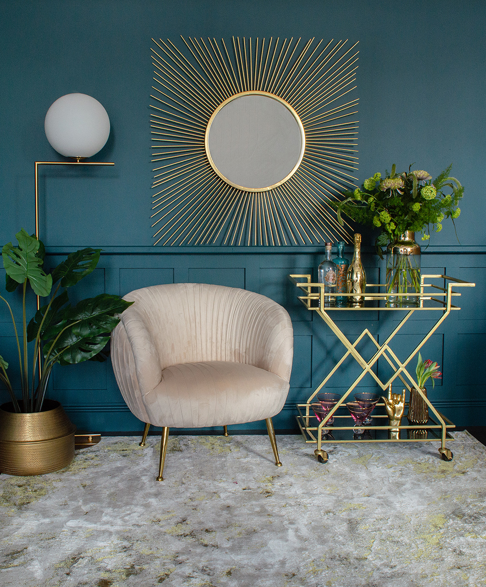 Glamorous living room with fabulous golden drinks trolley and square sunburst mirror