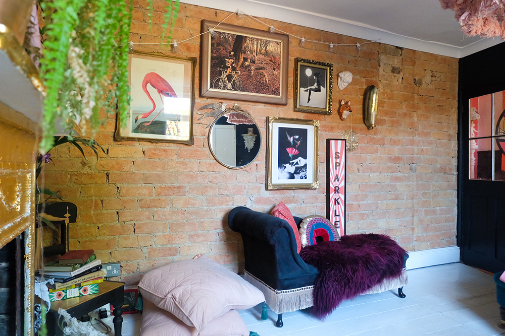 Eclectic interior decor with exposed brick feature wall.