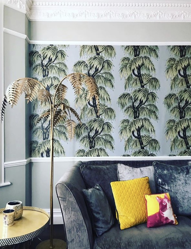 Tropical wallpaper in the living room, paired with our antique bronze palm leaf floor lamp