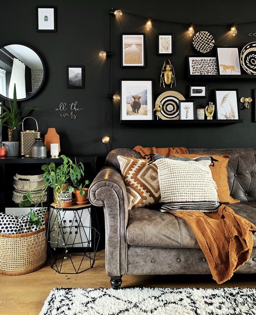 Black living room decor with quirky gallery wall inspiration, featuring out gold beetle wall decor