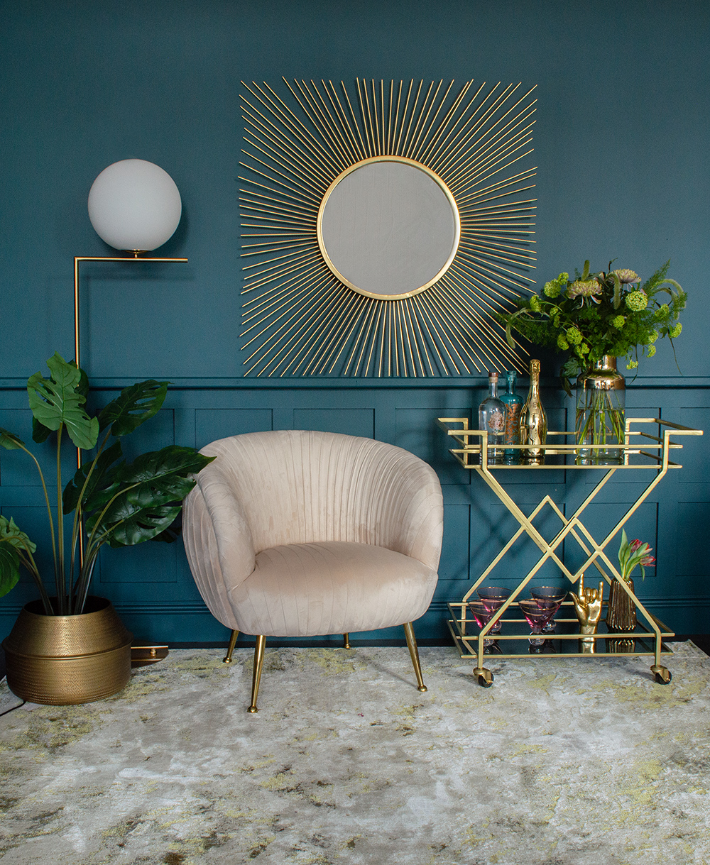 Art deco style interiors, Hollywood glam living room inspiration. Square sunburst mirror with art deco drinks trolley and blush pink velvet armchair