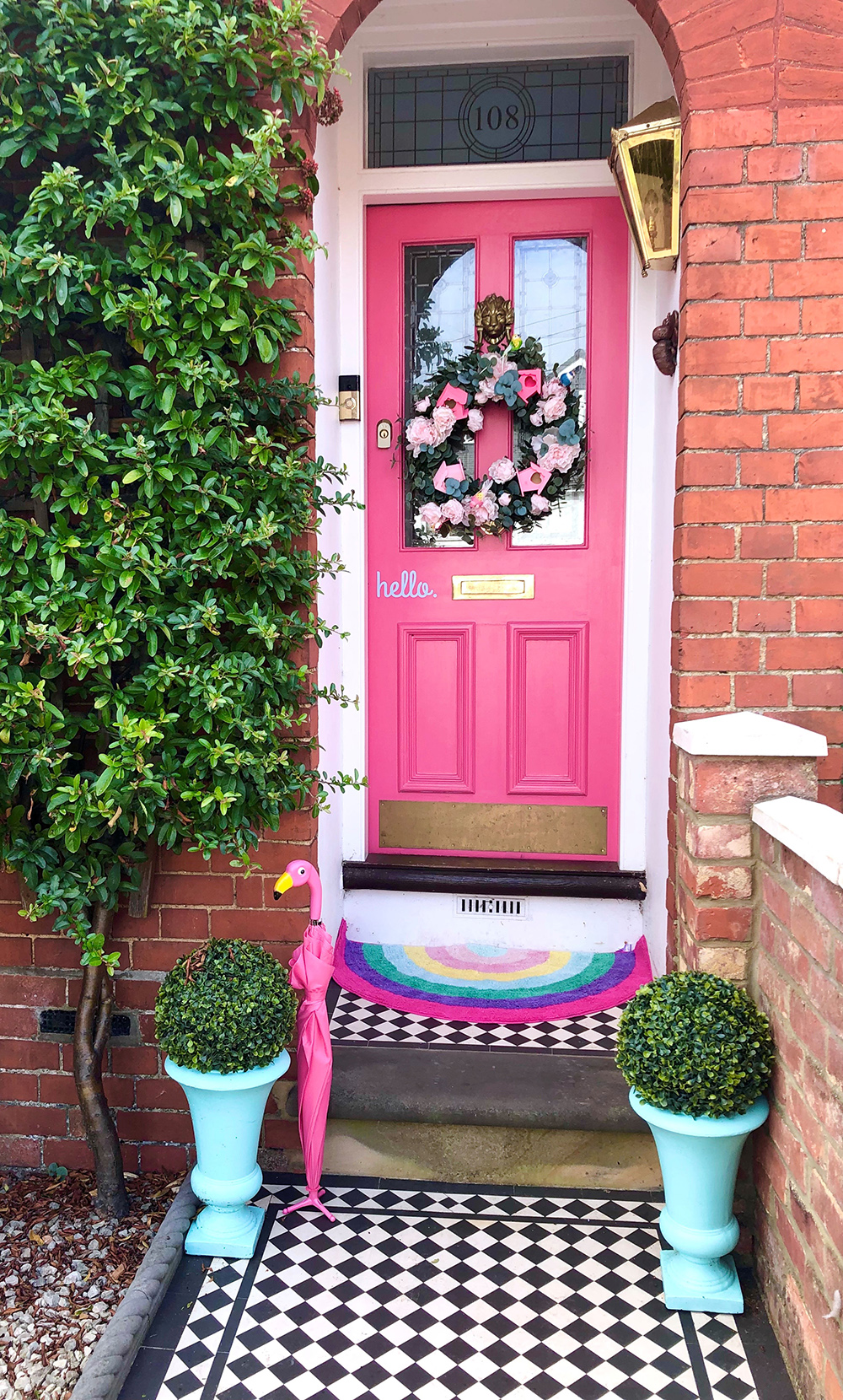 Fun family home decor - hot pink front door with monochrome floor tiles