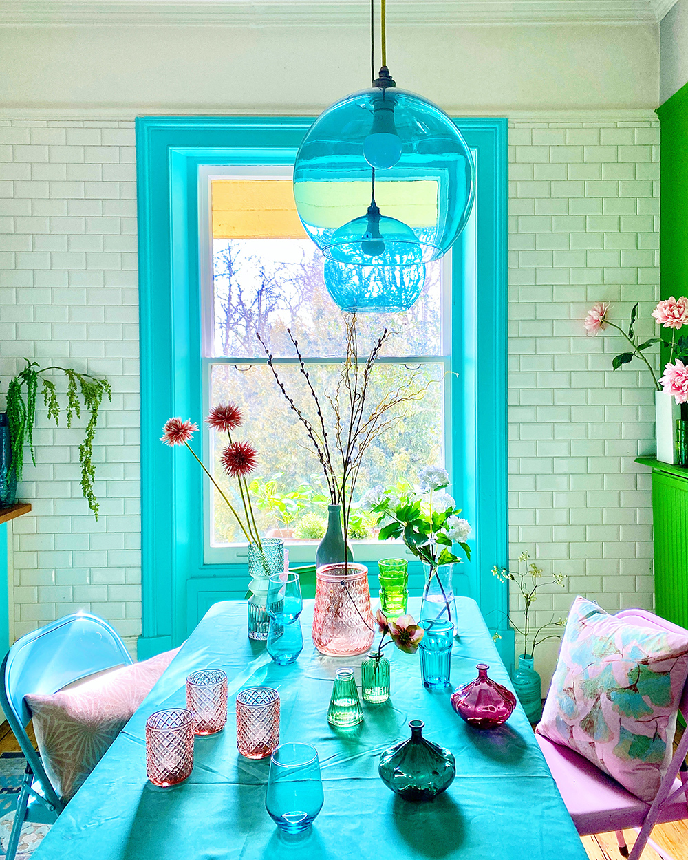 House tour of stunning London home with pastel hues and colourful wall murals - green and blue kitchen