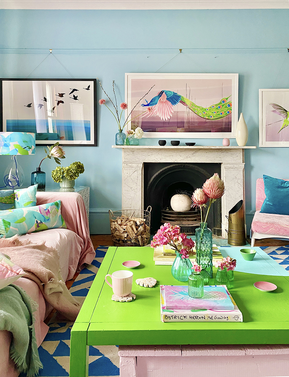 Quirky pastel blue living room with pops of green and blush pink