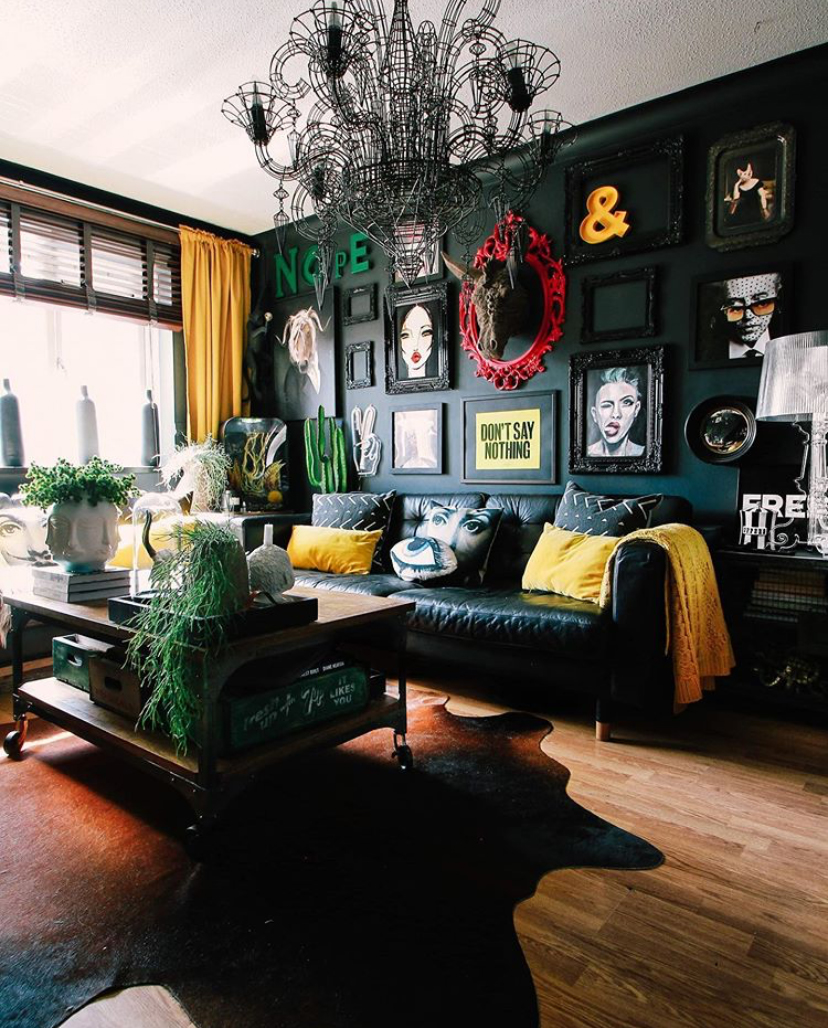 Black living room decor with quirky prints and wall art
