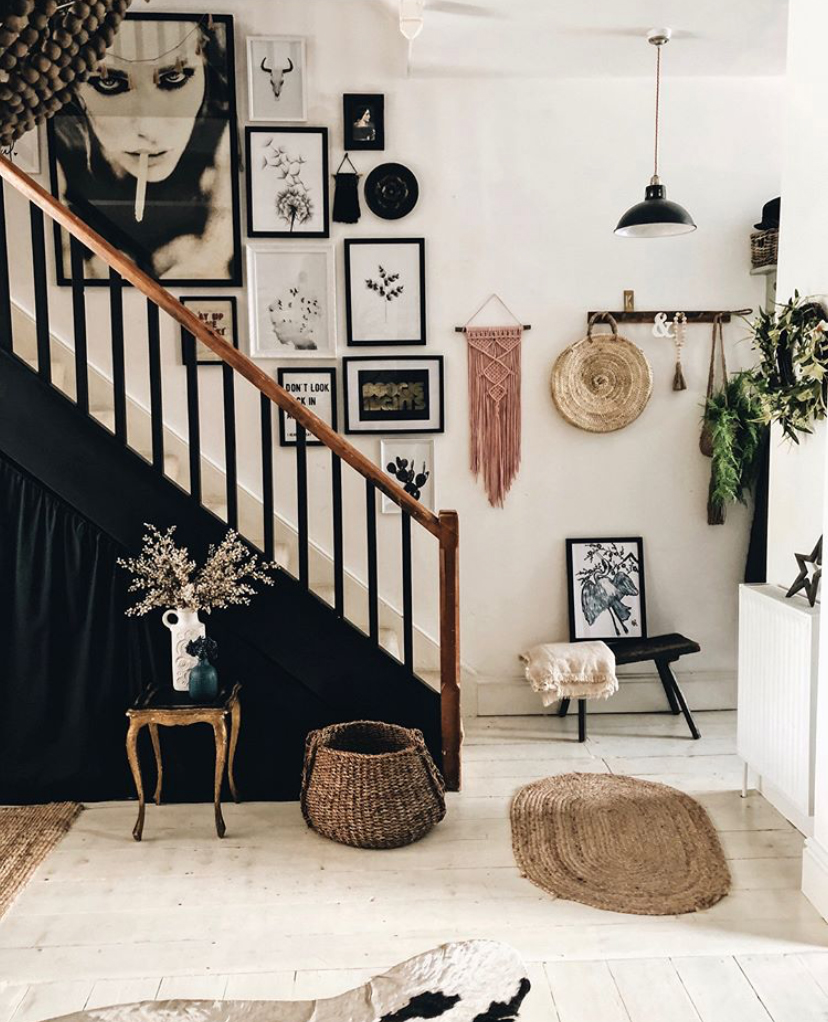 Monochrome hallway decor with staircase gallery wall