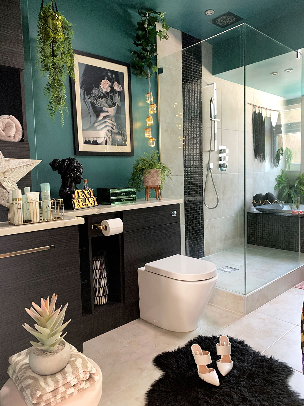 Quirky bathroom decor. Green and black colour palette with lush green house plants