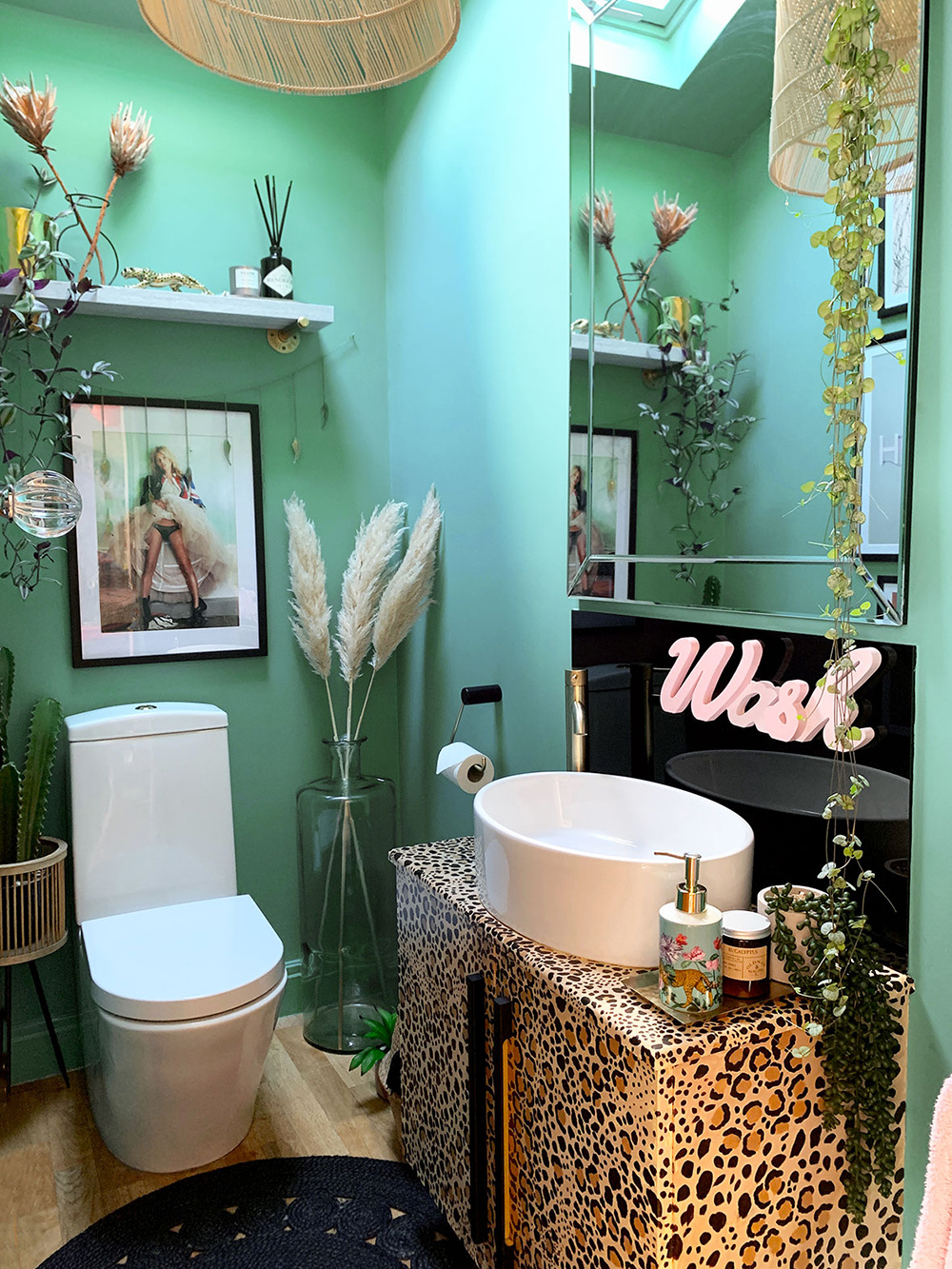 Quirky bathroom decor. Green and black colour palette with leopard print wash stand 