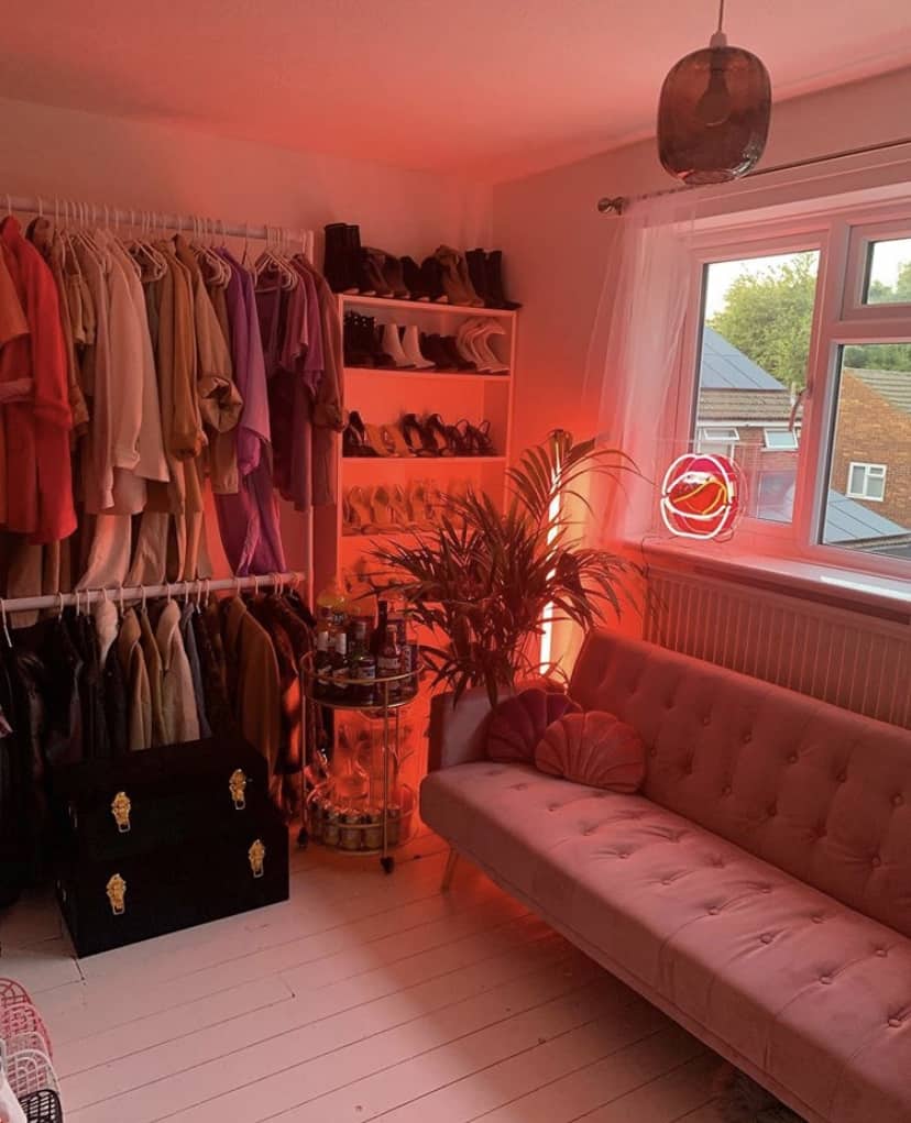 Glamorous dressing room decor with pink velvet sofa and pink neon lights