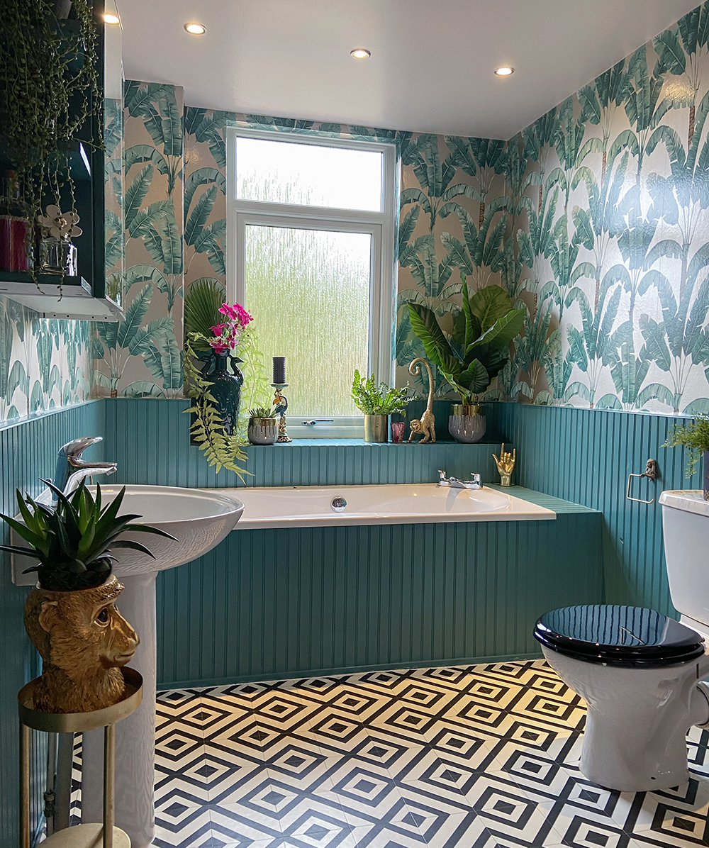 Tropical patterned wallpaper with teal panelling and patterned monochrome vinyl flooring