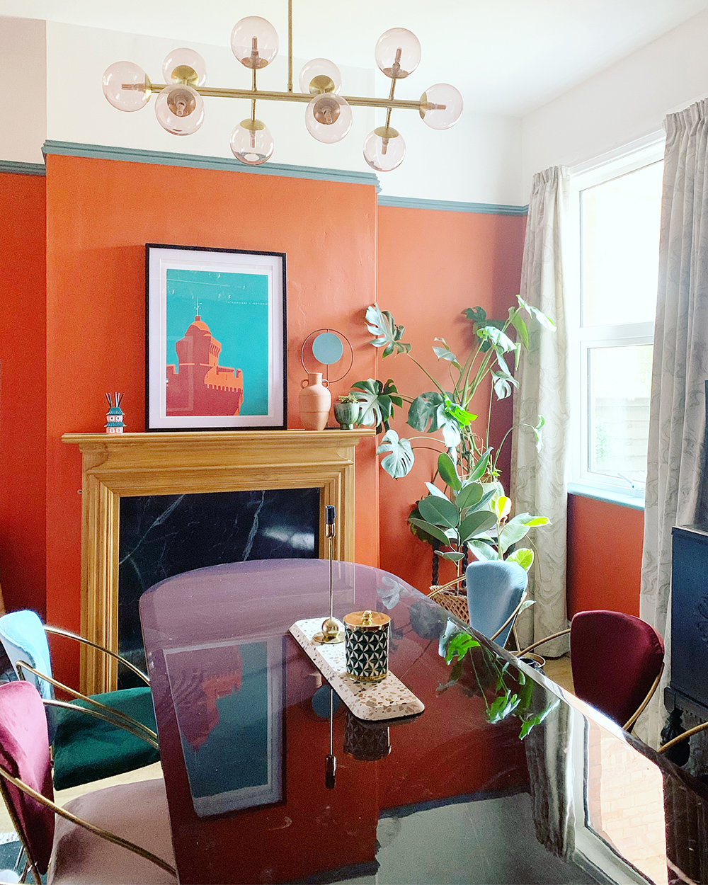 Retro vibe dining room with bold orange walls