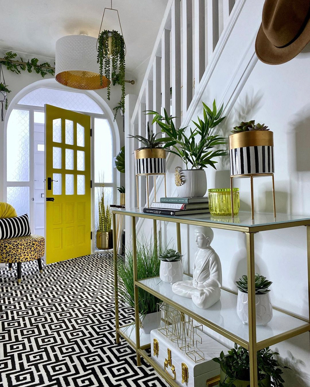 Stunning hallway inspiration with monochrome patterned carpet and yellow front door