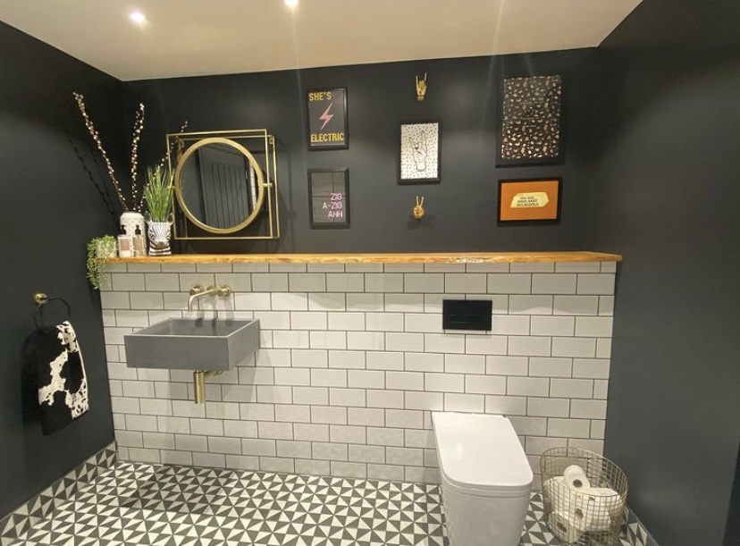 Black bathroom with gallery wall featuring our Gold Peace Hand and Gold Rock On Hand Wall Decor