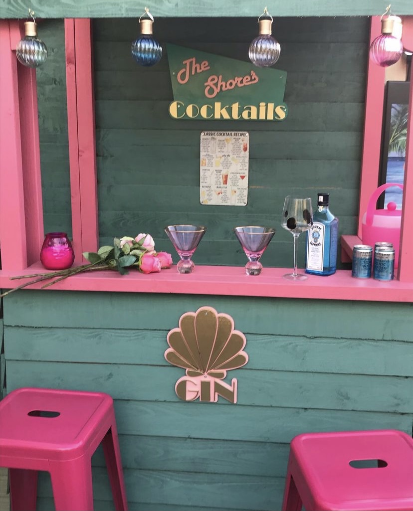Pink and green outdoor bar featuring our pink martini glasses