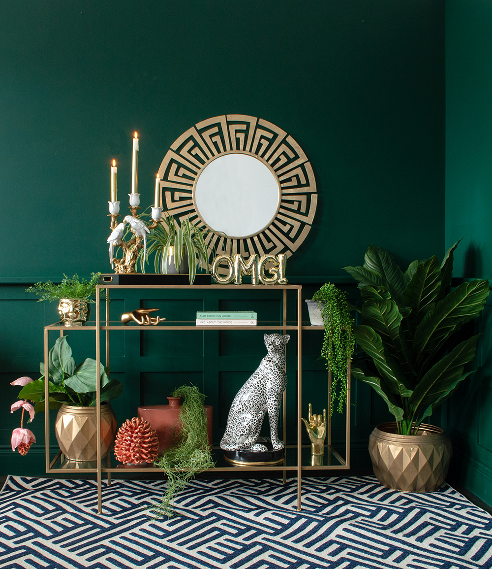 Moody green living room with colourful and quirky home accessories. We've styled our Gold OMG Balloon Ornament with an array of quirky homewares, including ourGreek Key Mirror, Lumi the Snow Leopard and White Lovebirds Candle Holder