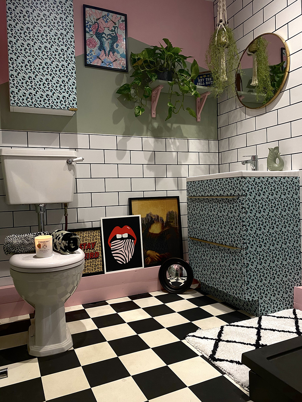 Quirky pink and green bathroom decor with black and white patterned floor tiles and gorgeous leopard print wallpaper on the furniture. By @inside.number.twelve 