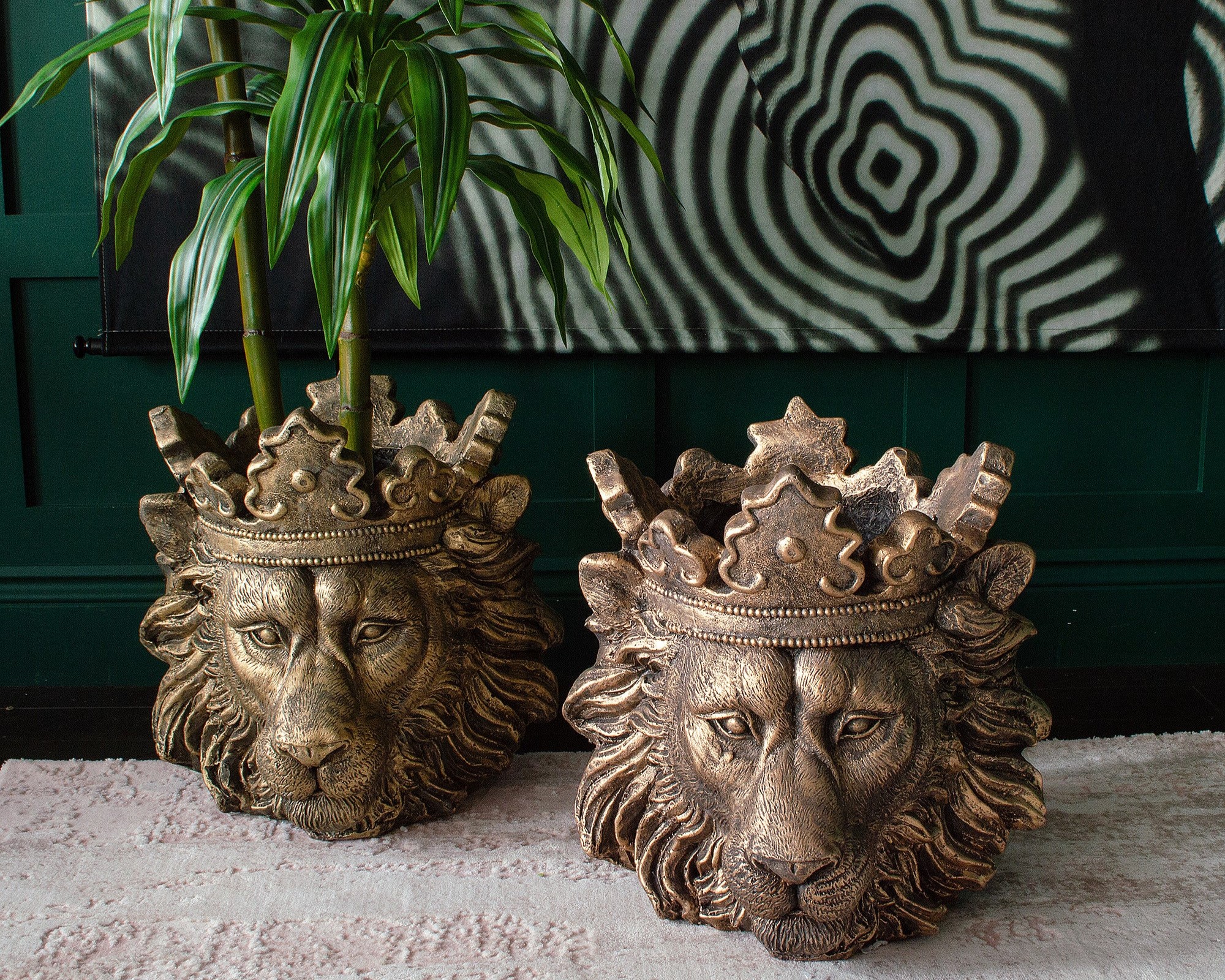 Two decorative lion head planters with crowns